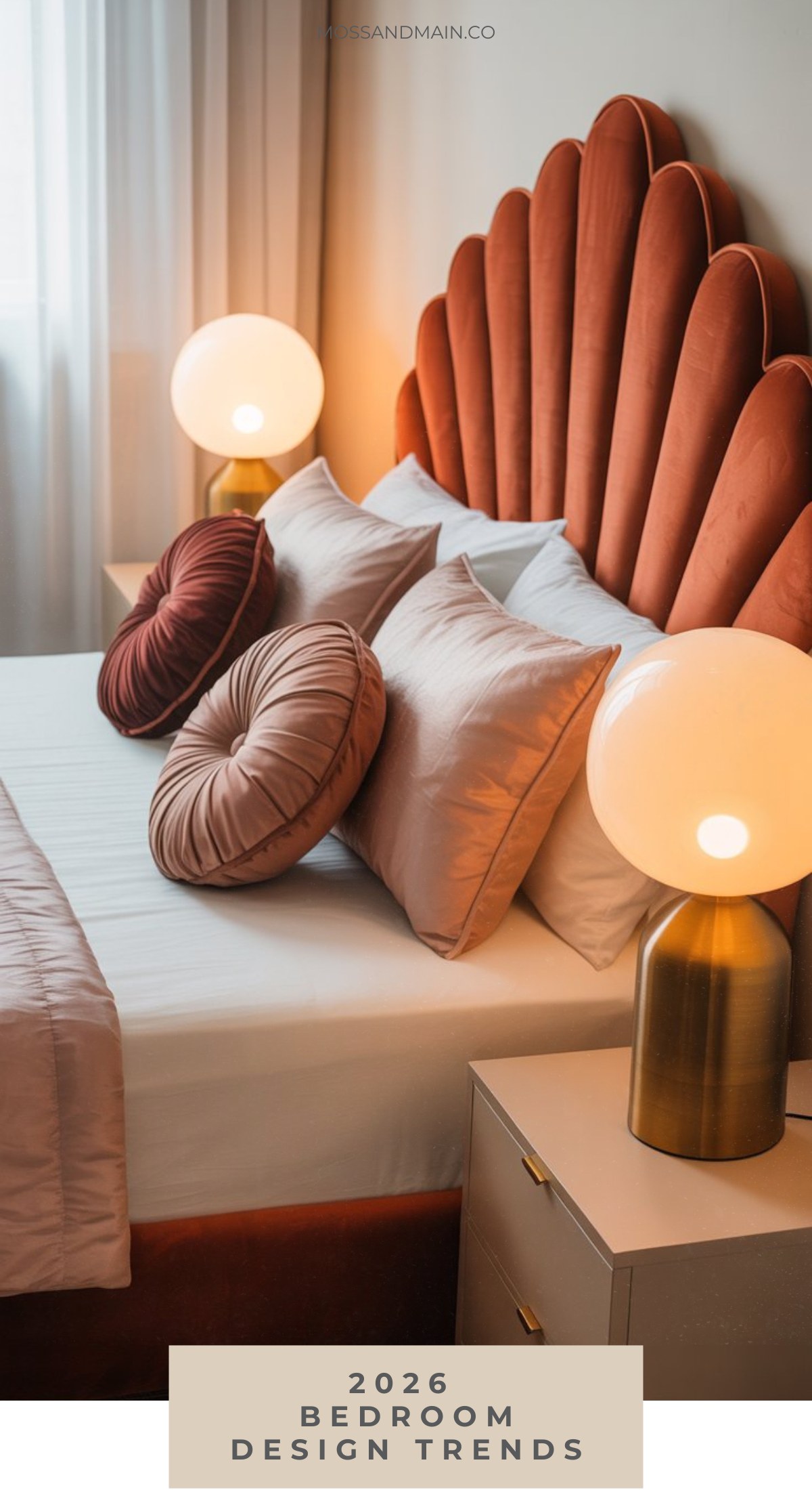 A stylish bedroom featuring a bold, scalloped rust-colored headboard, round accent pillows, white bedding, and modern globe lamps highlights the latest bedroom design trends. Text overlay reads 2026 Bedroom Design Trends.