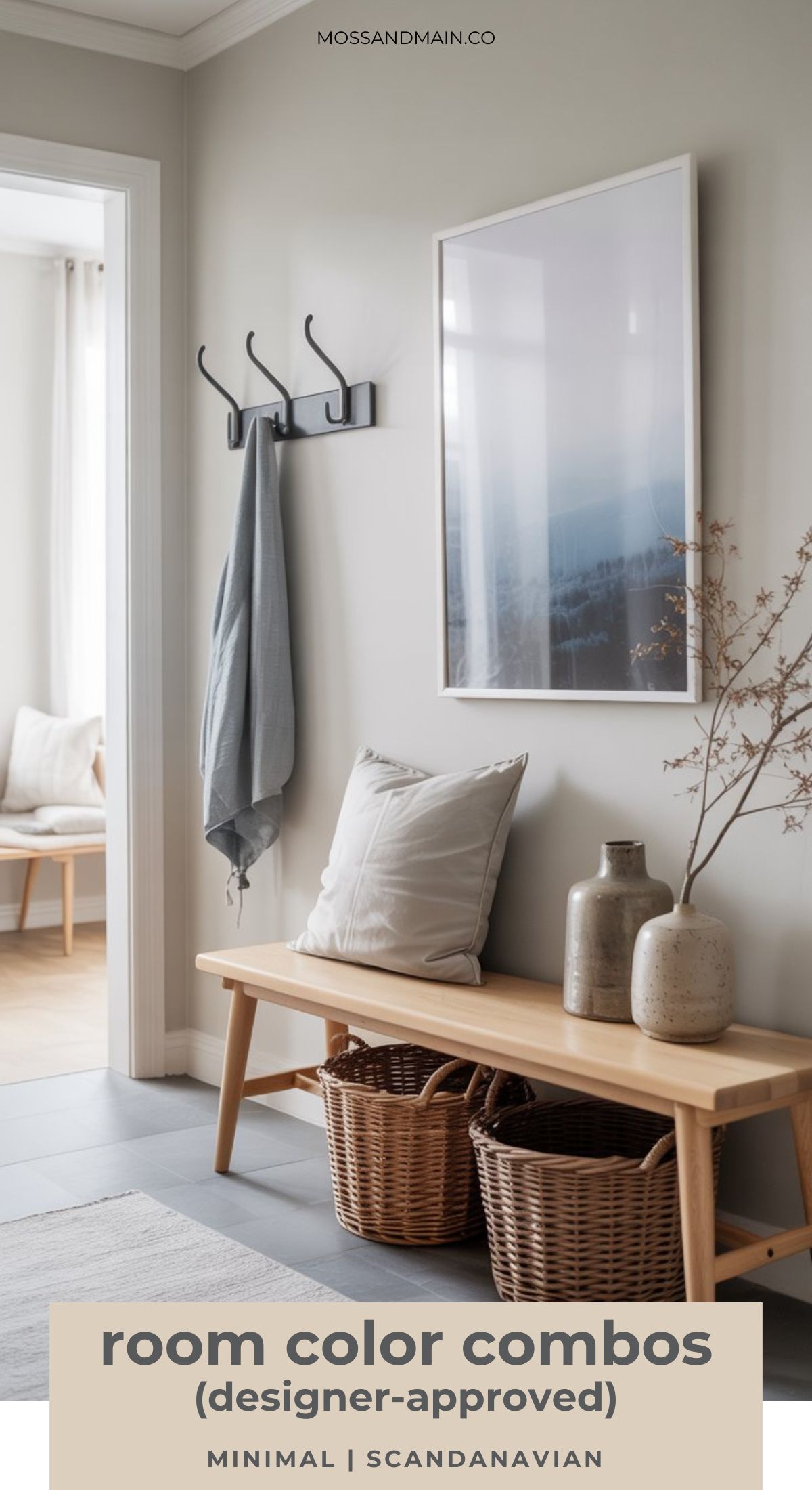 A minimalist entryway with a light wooden bench, wicker baskets, ceramic vases, and a large framed photo. Soft neutral tones and Scandinavian style decor create an interior design that showcases timeless color palettes throughout the space.