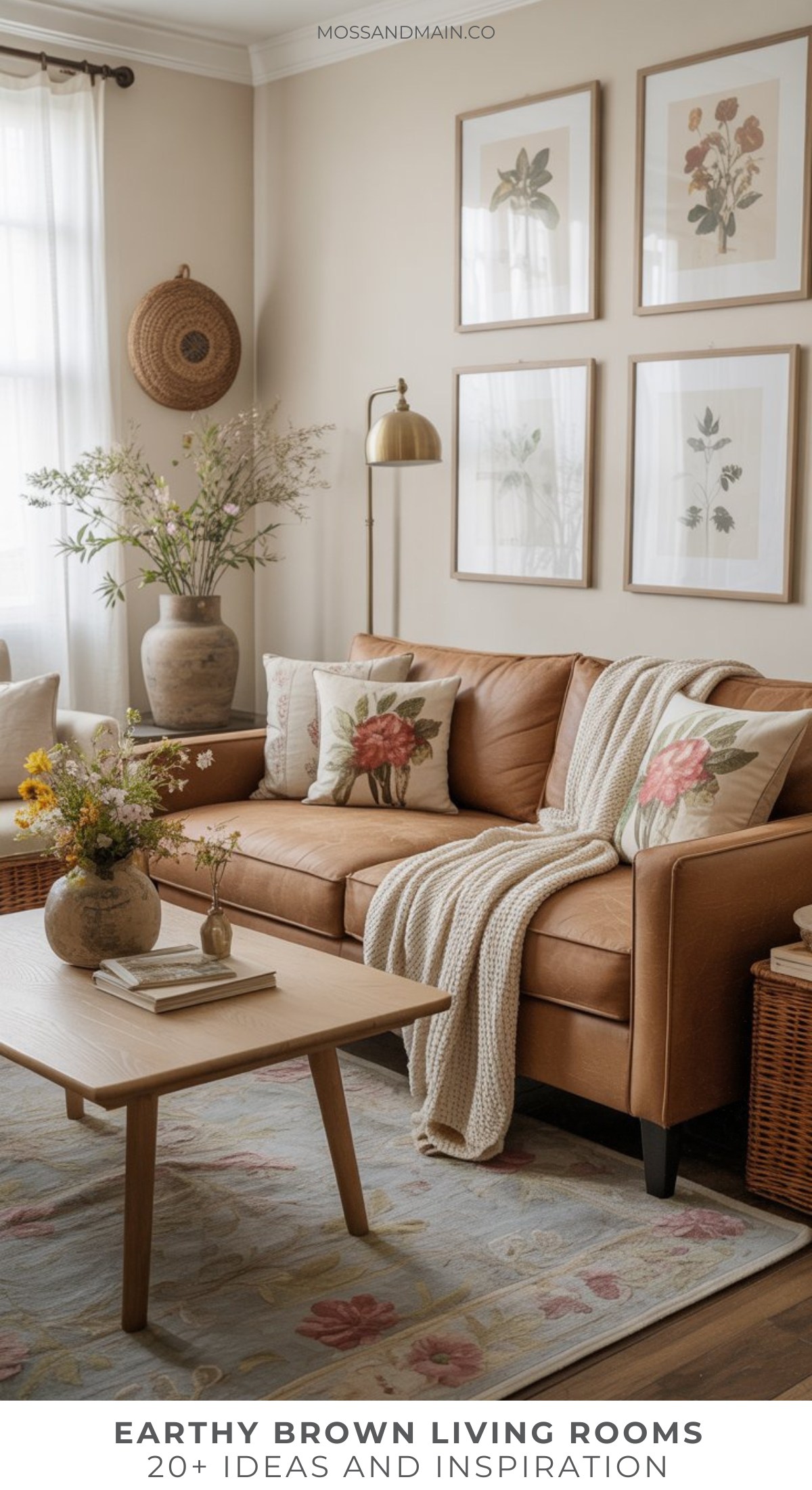 A cozy brown living room with a tan leather sofa, floral pillows, a knit throw, wooden coffee table with a vase of flowers, and botanical wall art—perfect inspiration for stylish brown living room ideas in earthy and neutral tones.