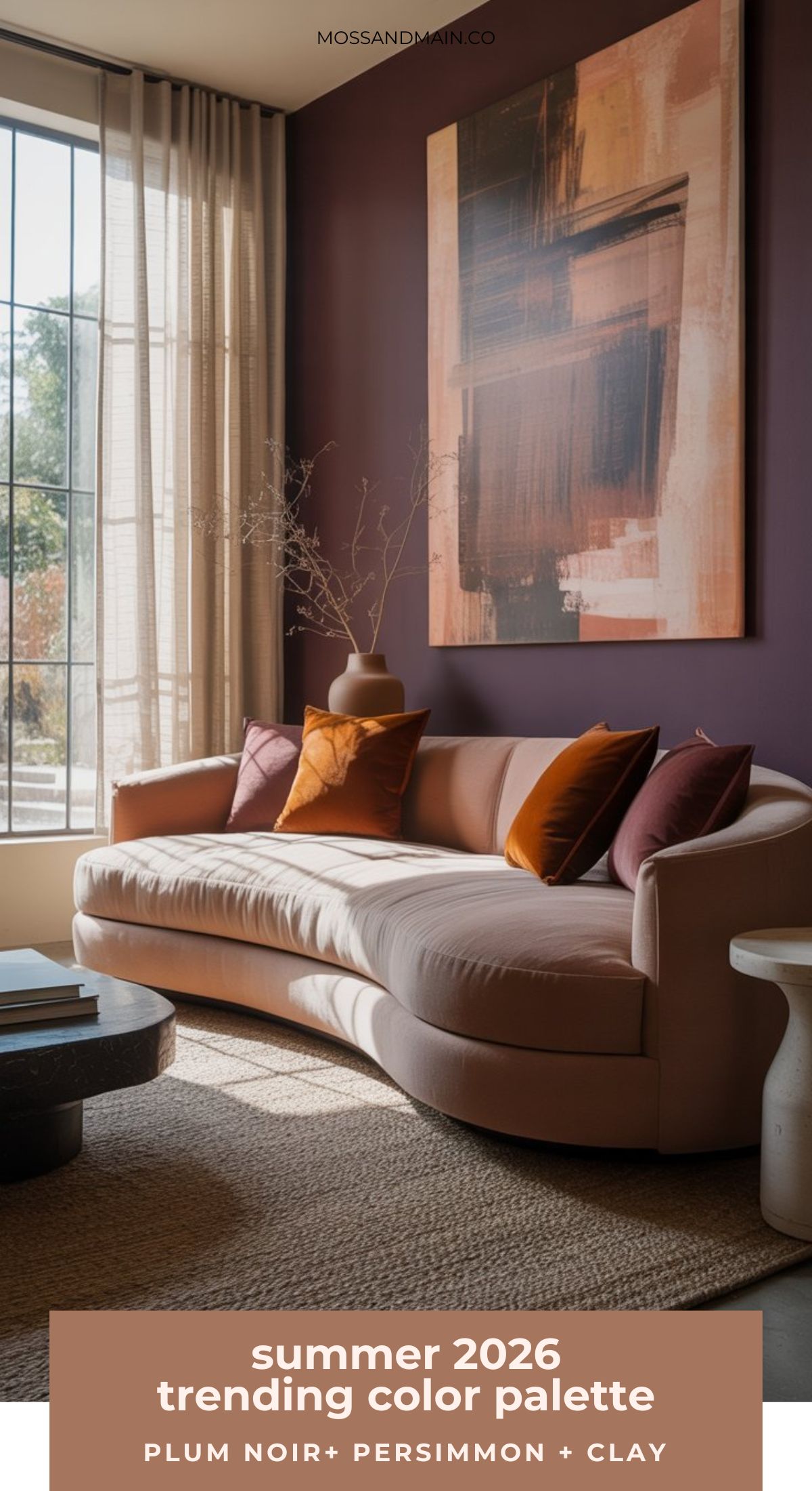 A modern living room features a plum noir accent wall, a curved beige sofa with pillows in color palettes of plum, persimmon, and clay, a large abstract painting, and sunlight streaming through tall windows with sheer curtains.