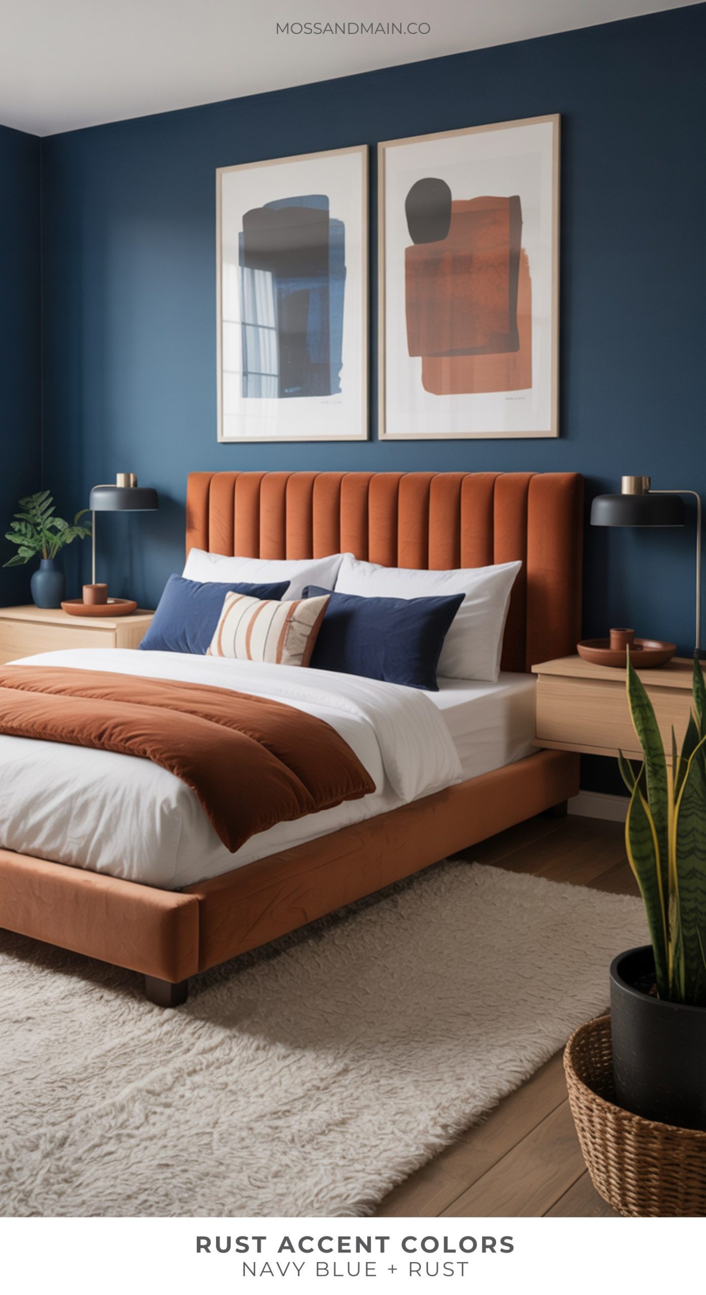 Modern bedroom featuring rust accent colors—a rust-colored bed, navy blue walls, abstract art, navy and rust pillows, light wood nightstands, black lamps, a white rug, and a basket with a plant. Text reads: Rust Accent Colors: Navy Blue + Rust.