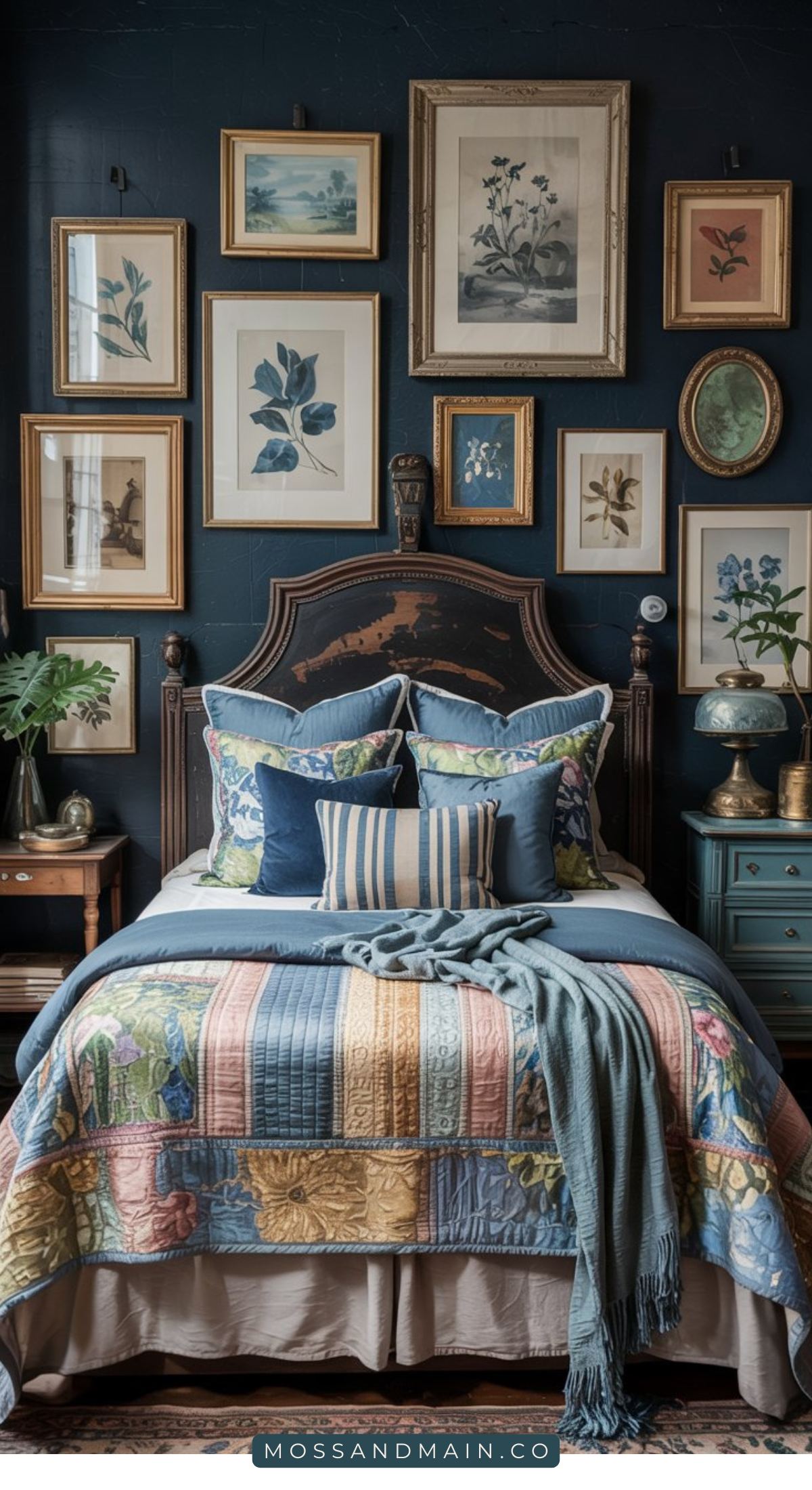 A cozy Blue Cottagecore Bedroom with a vintage wooden bed, floral and striped pastel bedding, and a blue throw. The dark wall behind the bed features framed botanical art, while side tables display plants and lamps.