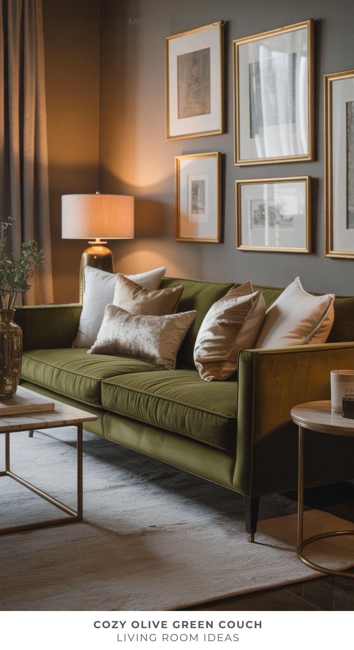 A cozy living room features an olive green sofa with white and beige pillows, a gold and glass coffee table, a lamp, and framed art on dark walls. Soft natural light filters through curtains, inspiring fresh living room ideas for interior design lovers.