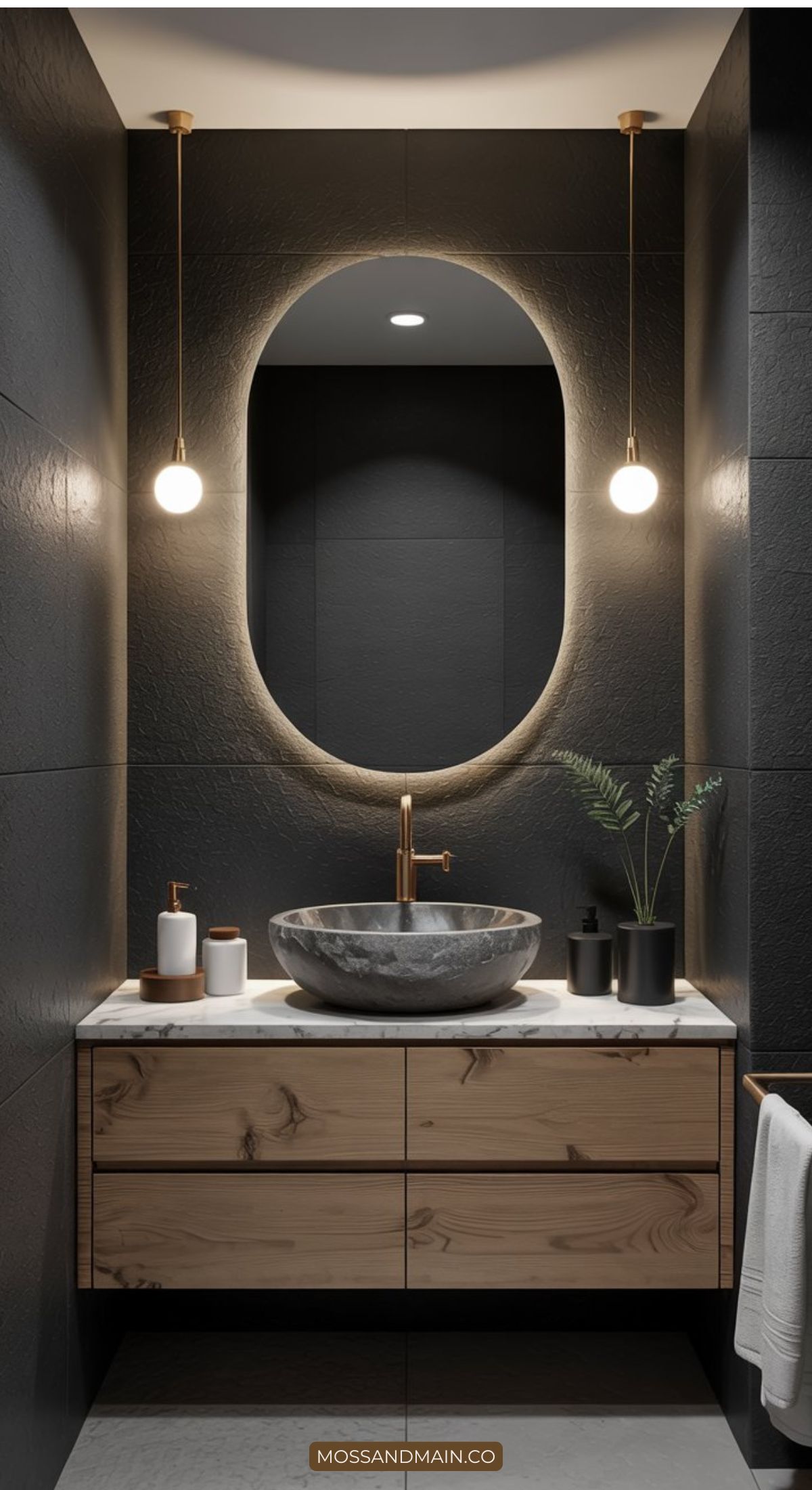 A modern bathroom vanity with a stone vessel sink, wood drawers, marble countertop, oval backlit mirror, gold faucet, and two hanging globe lights highlights key bathroom design elements; a small plant and toiletries add style to the counter.