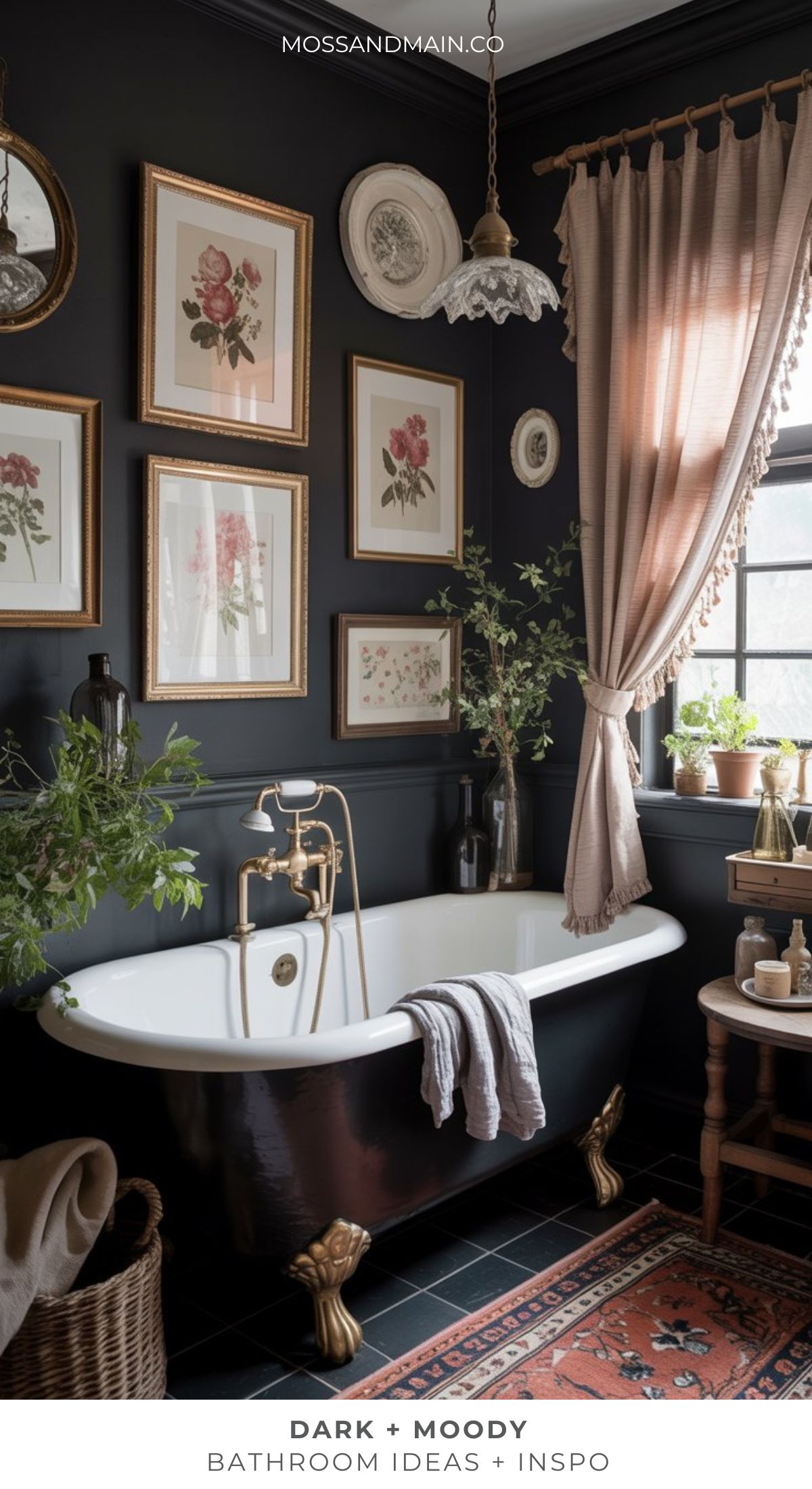 A timeless bathroom with dark, moody vibes features a black clawfoot tub with gold fixtures, blush curtains, framed botanical art, lush plants, and an ornate rug—perfect for those seeking dark bathroom ideas with vintage elegance.