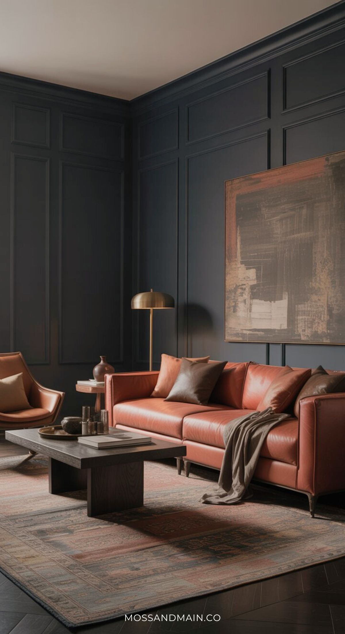 A modern living room with dark walls features a rust couch, accented by a large abstract painting, cushions, a throw blanket, an armchair, coffee table, floor lamp, and patterned rug. This space blends cozy elegance with fresh living room ideas.