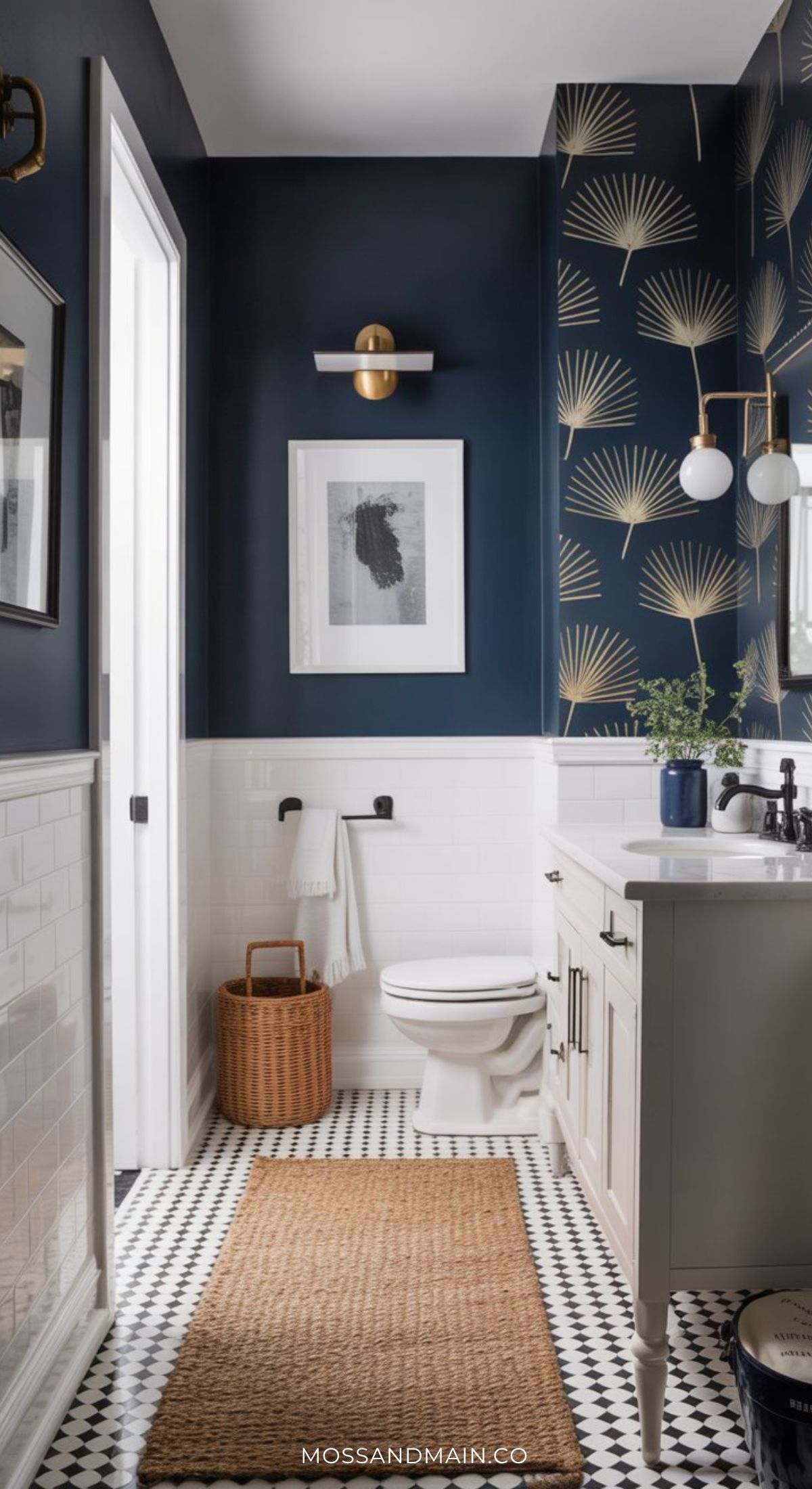 A dramatic bathroom with navy blue walls, white tile wainscoting, a patterned accent wall, black and white checkered floor, a white vanity, modern fixtures, a jute rug, and a wicker basket near the toilet offers bold dark bathroom ideas.
