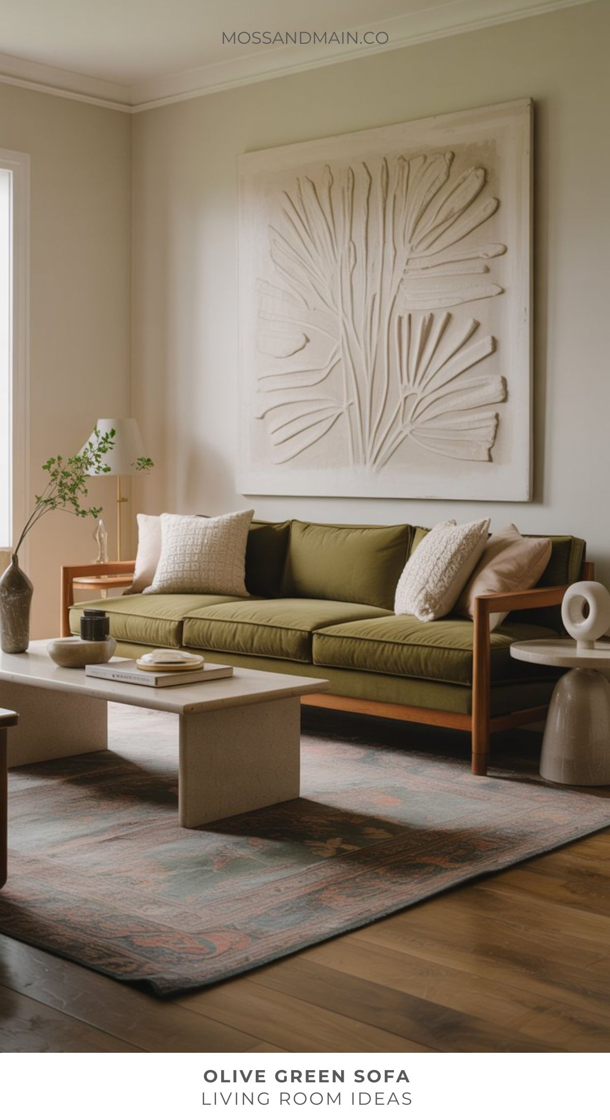 A modern living room featuring an olive green sofa, neutral pillows, and a light coffee table. Inspired by top designers’ living room ideas, abstract wall art and minimalist decor complete the cozy, stylish space.