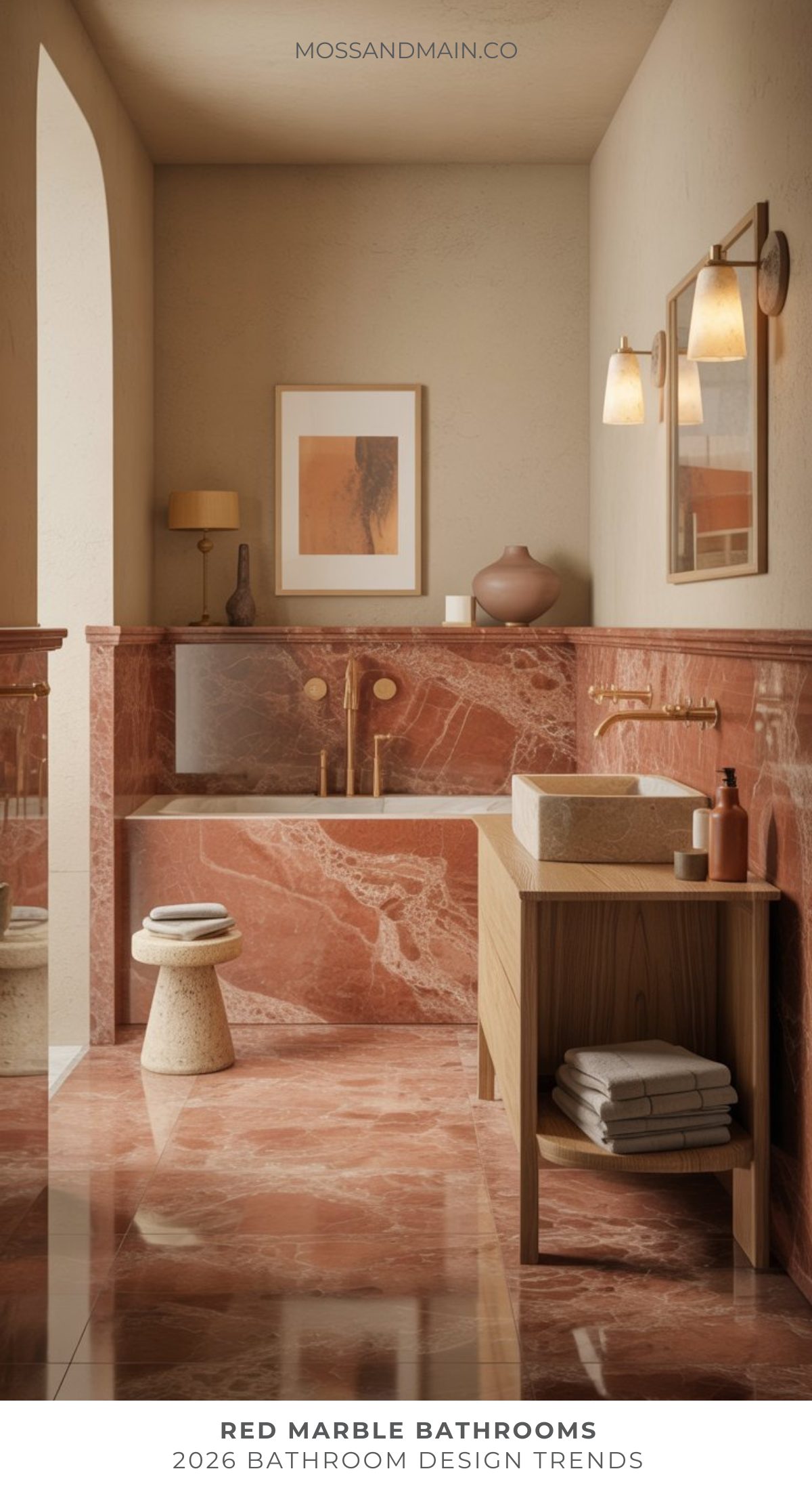 Luxurious red marble bathroom featuring bold marble floors and wall panels, a modern soaking tub, gold fixtures, wood vanity with folded towels, small stool, and soft lighting. Neutral decor accents add warmth and elegance to this striking bathroom design.