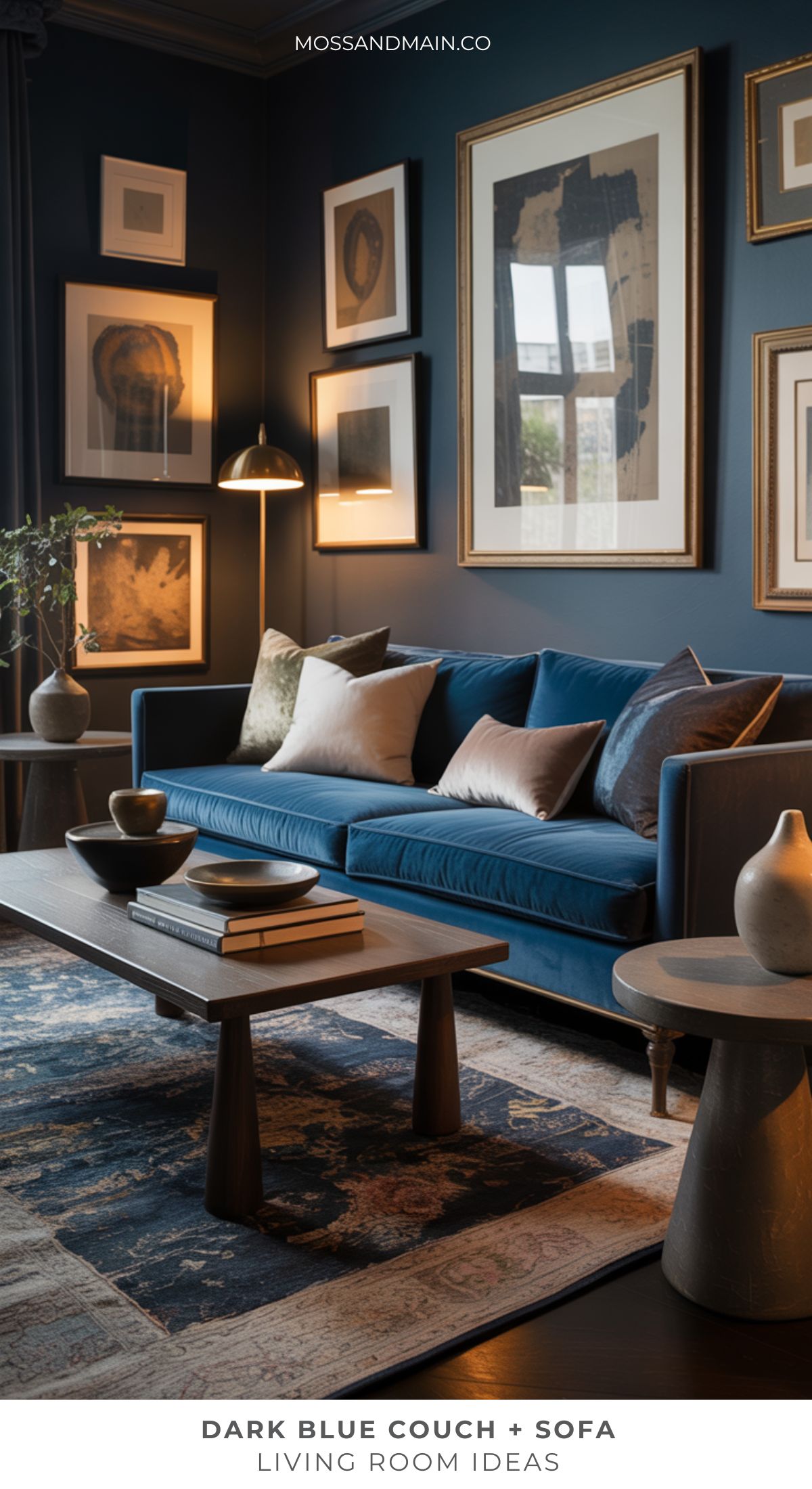 A stylish blue couch living room features a dark blue sofa, coffee table, decorative vases, patterned rug, and a gallery wall of framed art. Warm lighting and plush pillows add to the cozy, inviting atmosphere.