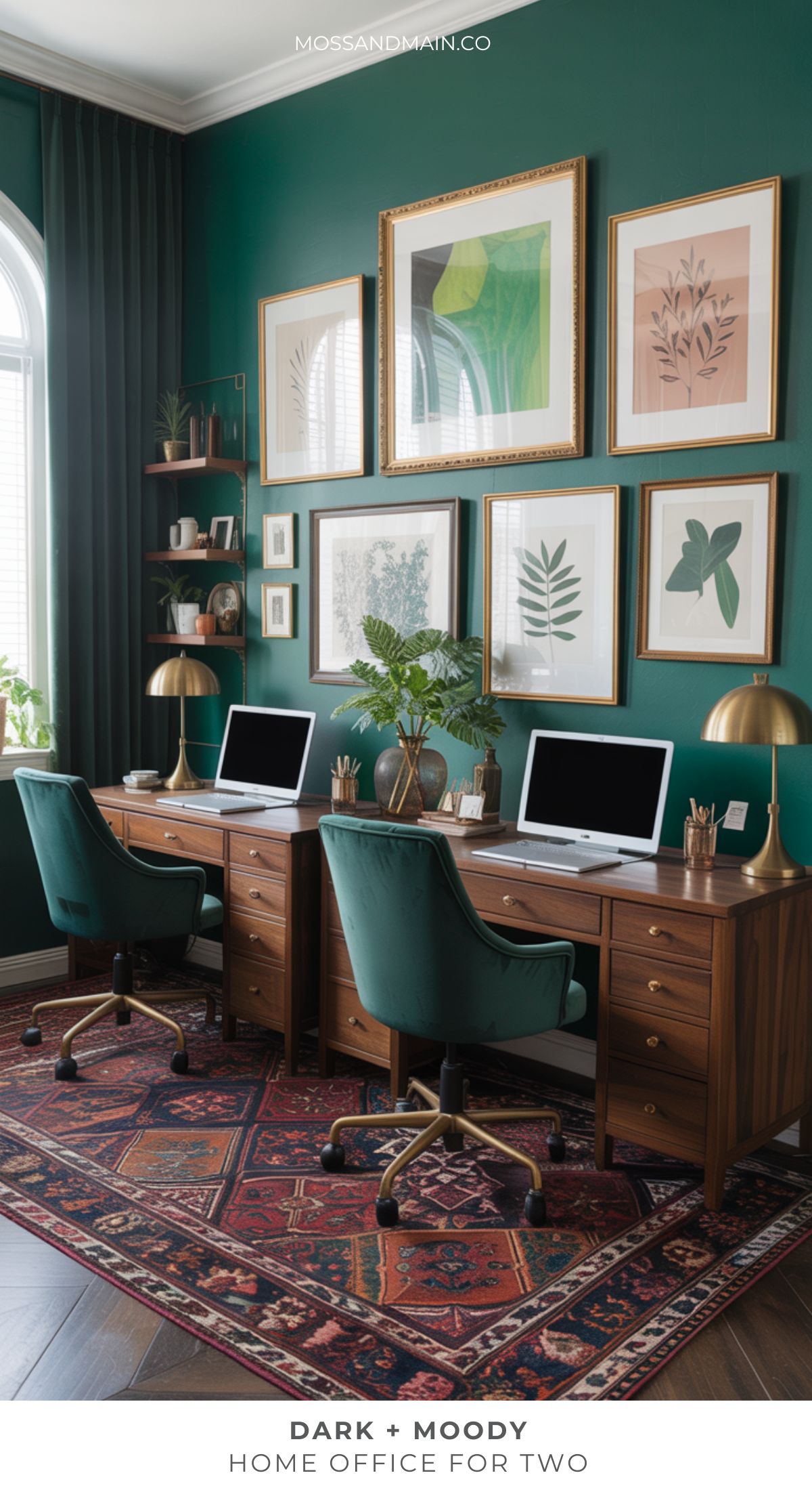 A stylish moody home office for two with dark green walls, wood desks, green chairs, gold lamps, botanical wall art, decor shelves, a large arched window, and a patterned rug creates a sophisticated and dark home office atmosphere.