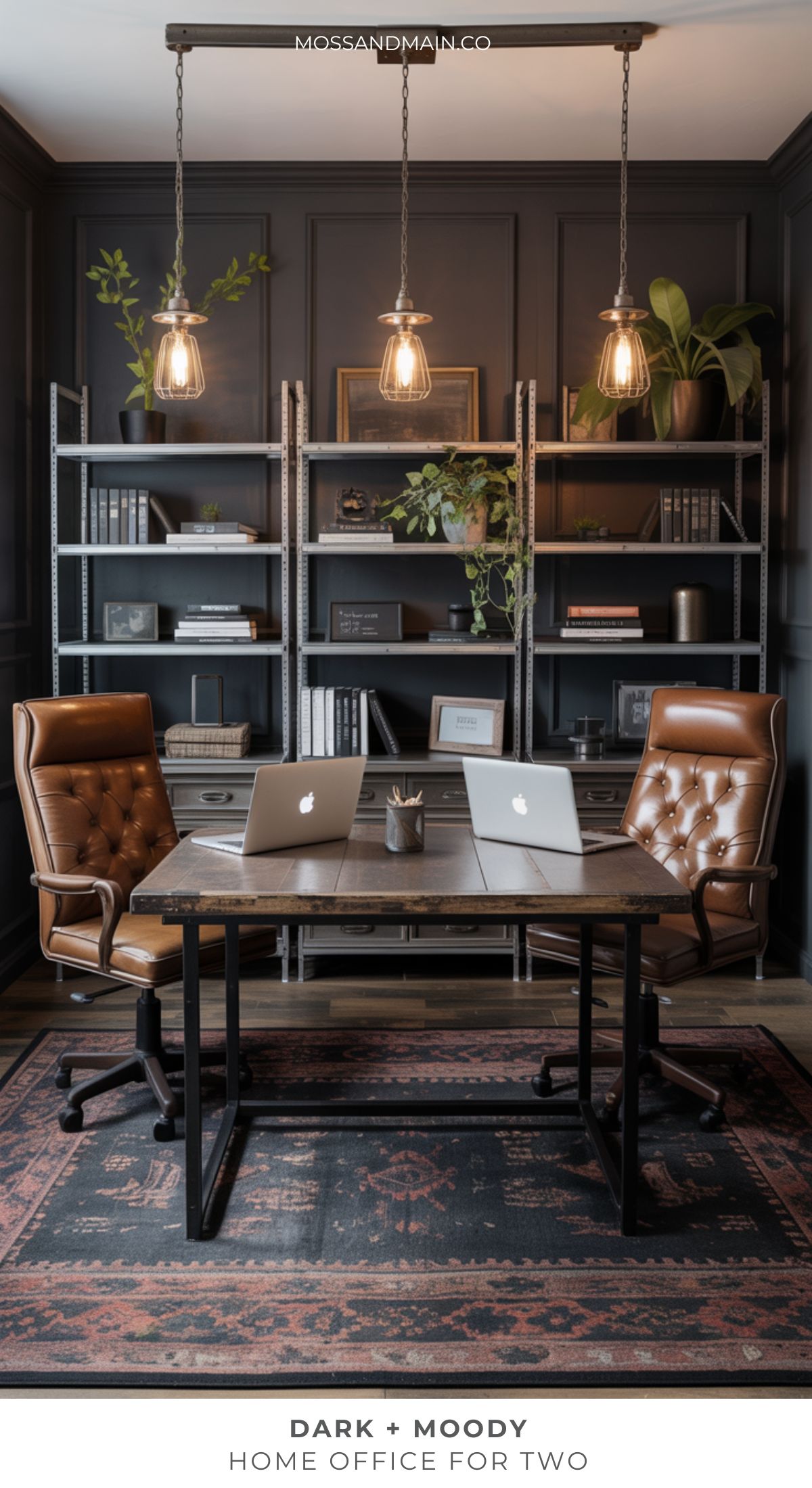 A stylish moody home office for two with brown leather chairs, a shared desk, two laptops, industrial bookshelves, pendant lights, plants, and a patterned rug. The space feels modern and sophisticated.