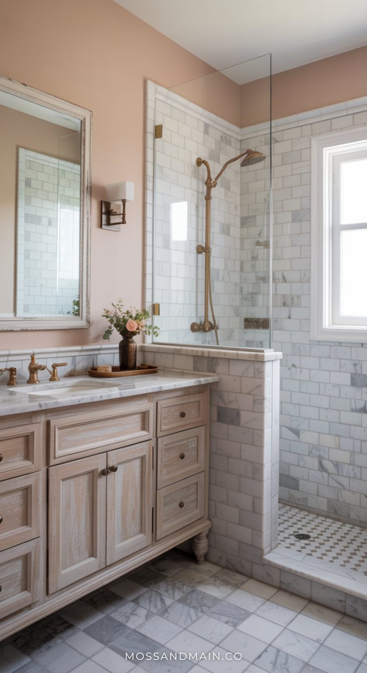 A stylish bathroom with a wooden vanity, marble countertop, gold fixtures, and bold bathroom decor. The glass-enclosed shower features white subway tiles, while a window lets in natural light and a small vase with flowers sits on the counter.