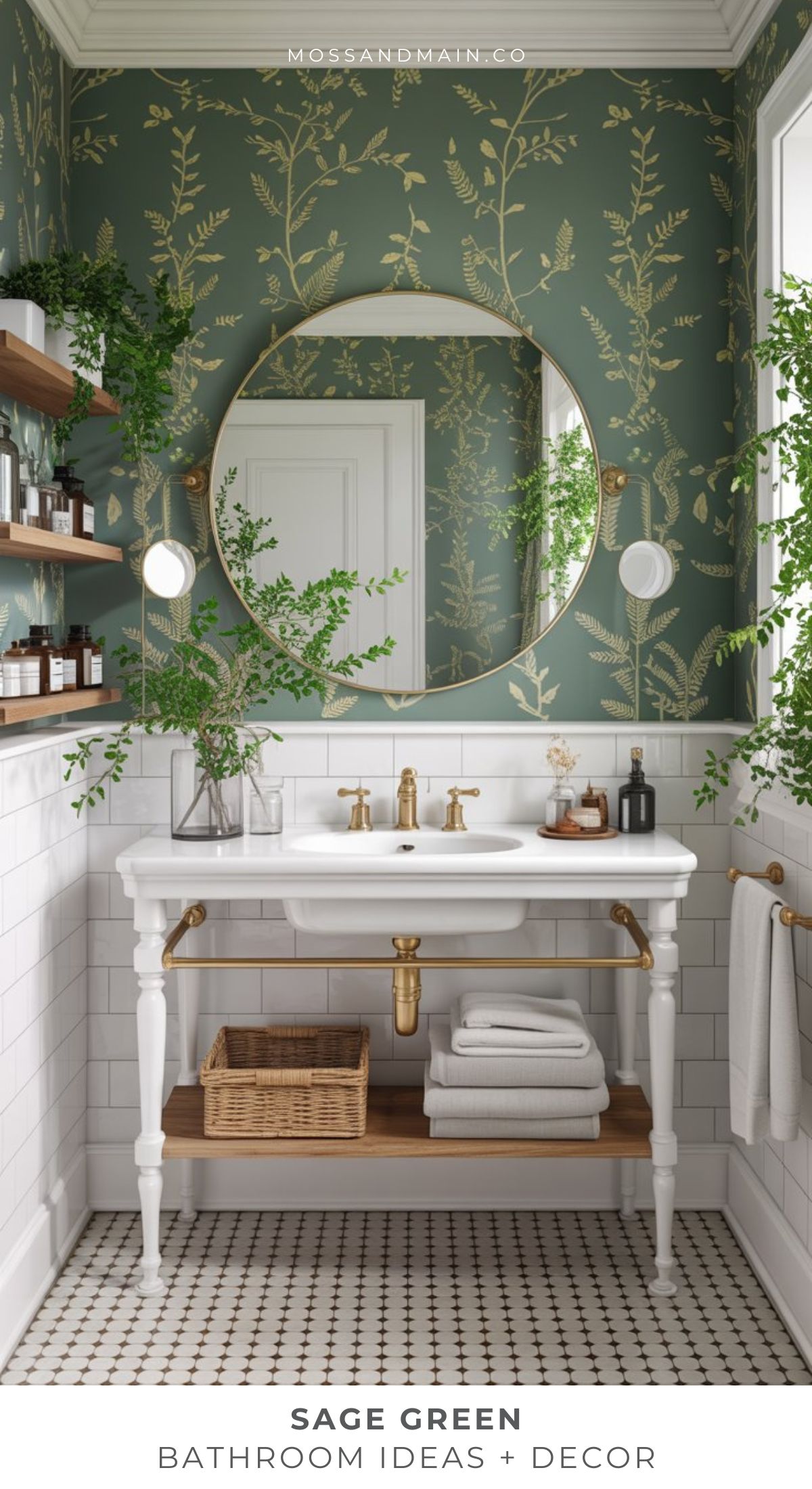 A stylish sage green bathroom with botanical wallpaper, a round mirror, white sink vanity with gold fixtures, open wood shelves with decor, and greenery accents creates a fresh, elegant look—perfect for inspiring your next bathroom ideas.