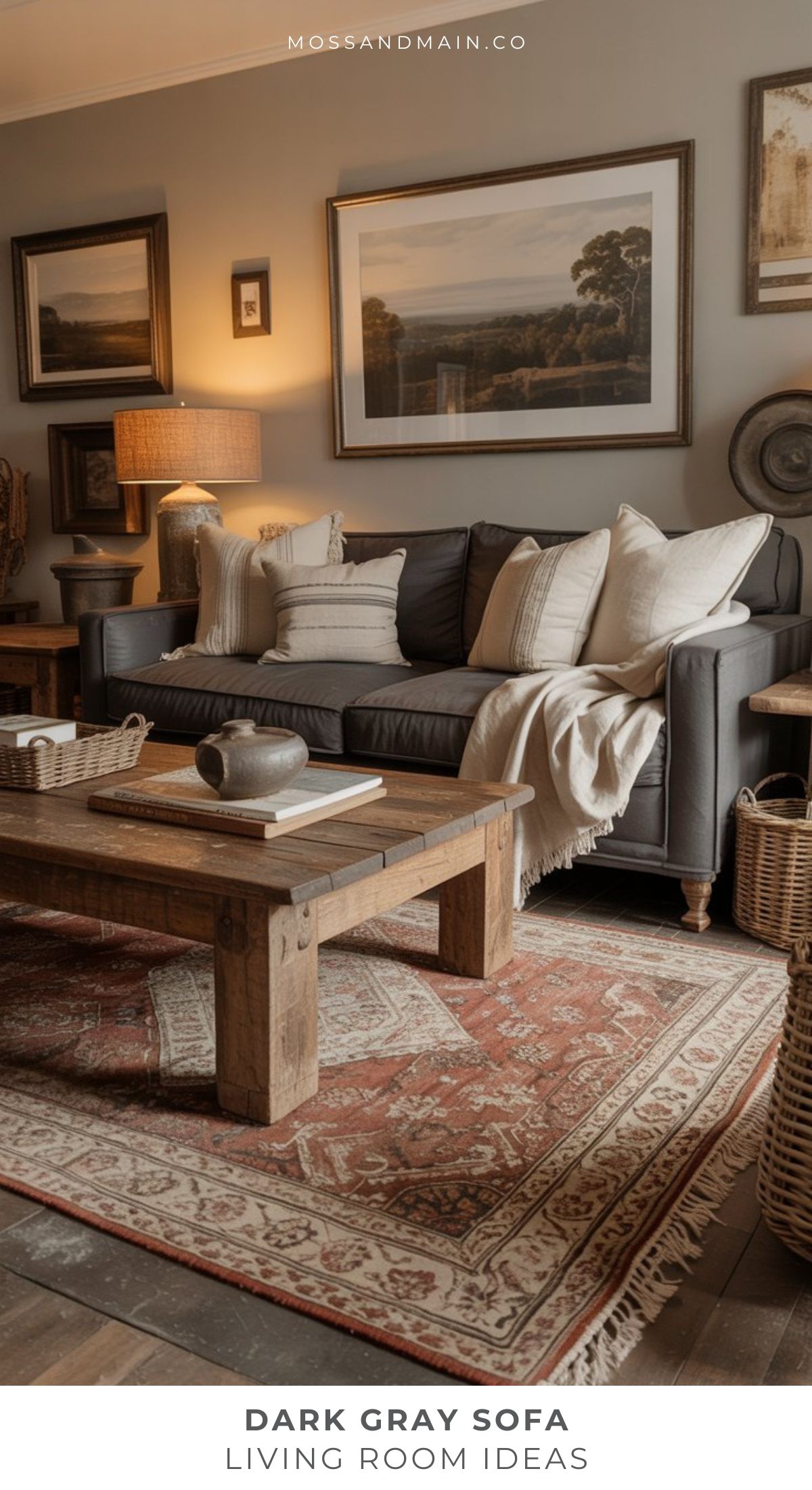 A cozy living room with a gray couch, neutral pillows and throws, wooden coffee table, woven baskets, table lamp, framed artwork on gray walls, and a patterned red area rug—perfect for those seeking inspiring living room ideas.