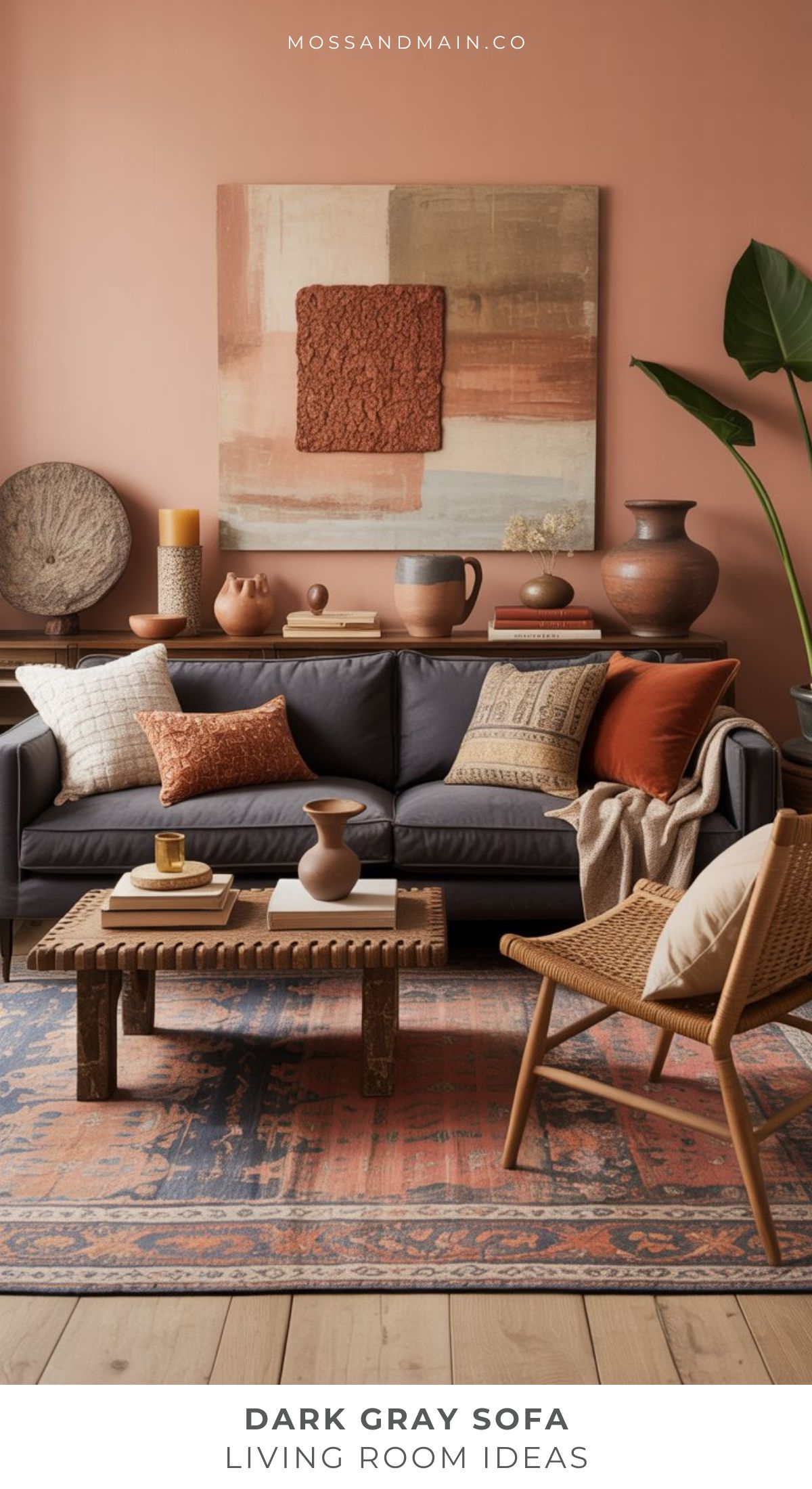 A cozy living room featuring a gray couch, earth-toned pillows, a wooden coffee table, woven chair, and terracotta decor. Abstract art pops on a peach wall with plants and pottery—perfect inspiration for gray couch living room ideas.