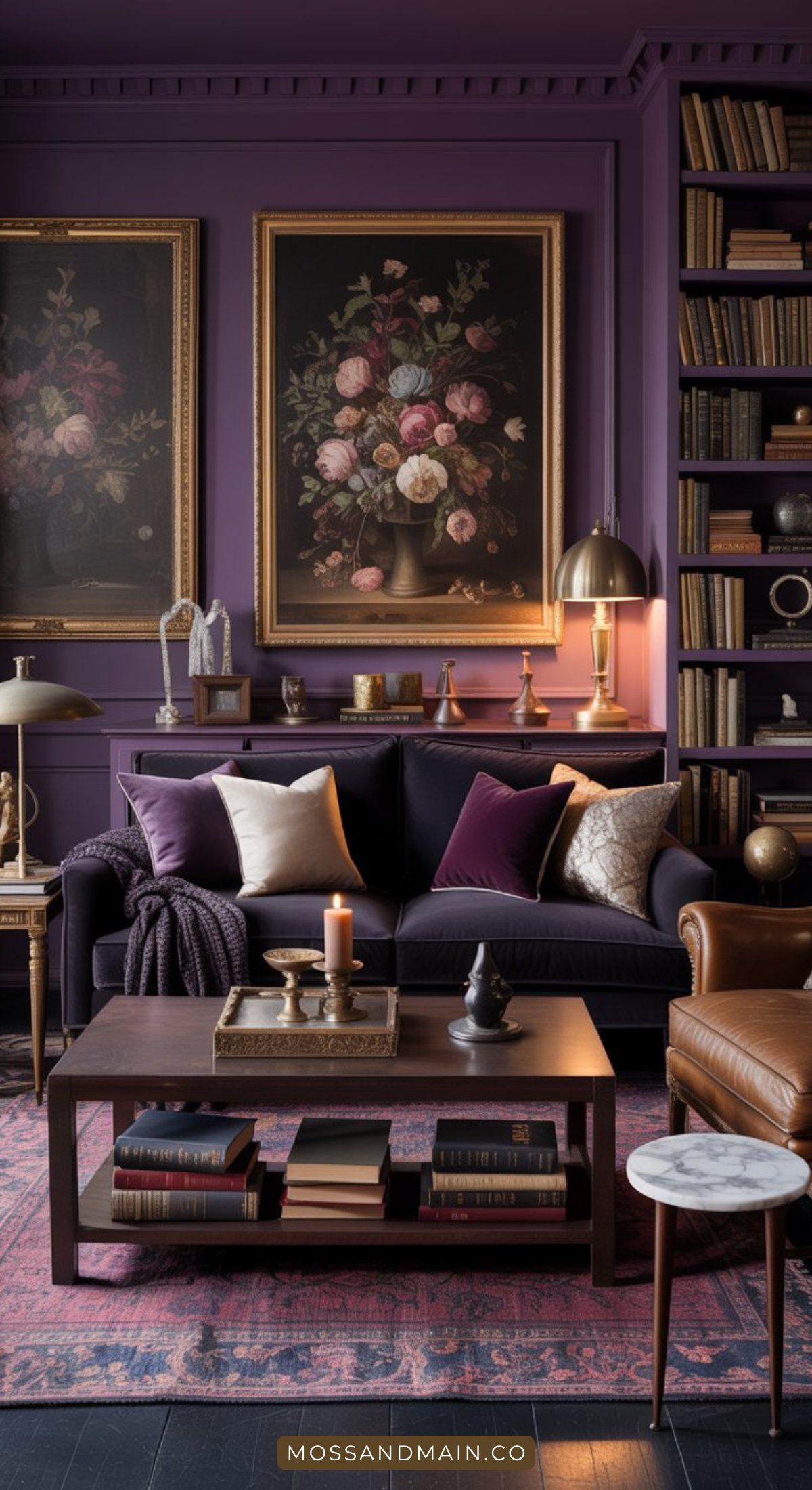 A cozy living room with purple walls, a dark velvet sofa and assorted cushions, classic floral paintings, bookshelves, warm lighting, and a wooden coffee table—perfect inspiration for moody living room decor enthusiasts.