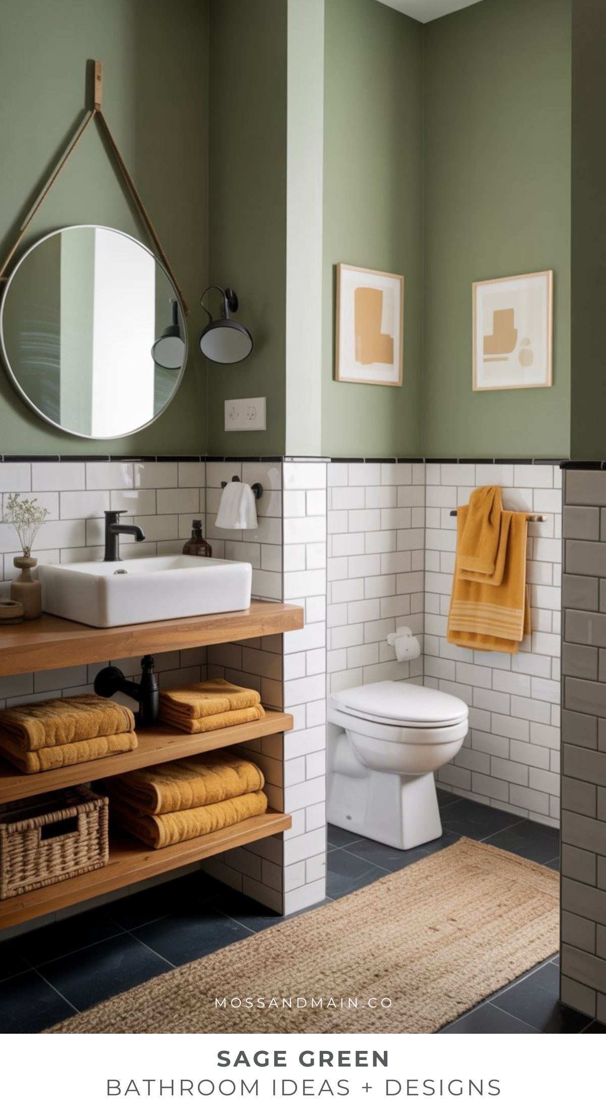 A cozy bathroom with sage green walls, white subway tiles, a round mirror, wood shelves with mustard towels, a white sink, and a toilet. Minimalist art and a woven rug complete this timeless bathroom décor.