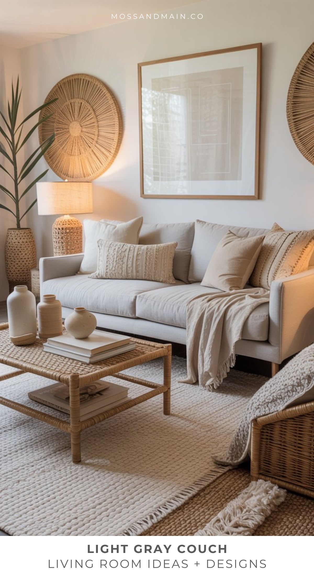 A modern gray couch living room with neutral decor, woven accents, potted plants, a wooden coffee table, and framed wall art creates a cozy, minimalist, and inviting atmosphere.