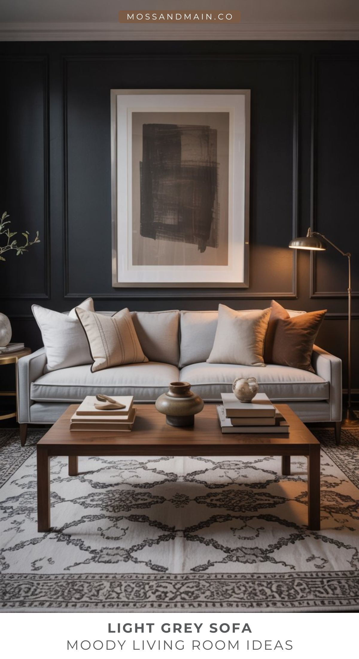 A modern living room featuring a light gray couch, neutral throw pillows, a wooden coffee table with decor, a patterned rug, and abstract wall art. Warm lighting and dark walls create cozy vibes—perfect for those seeking stylish living room ideas.