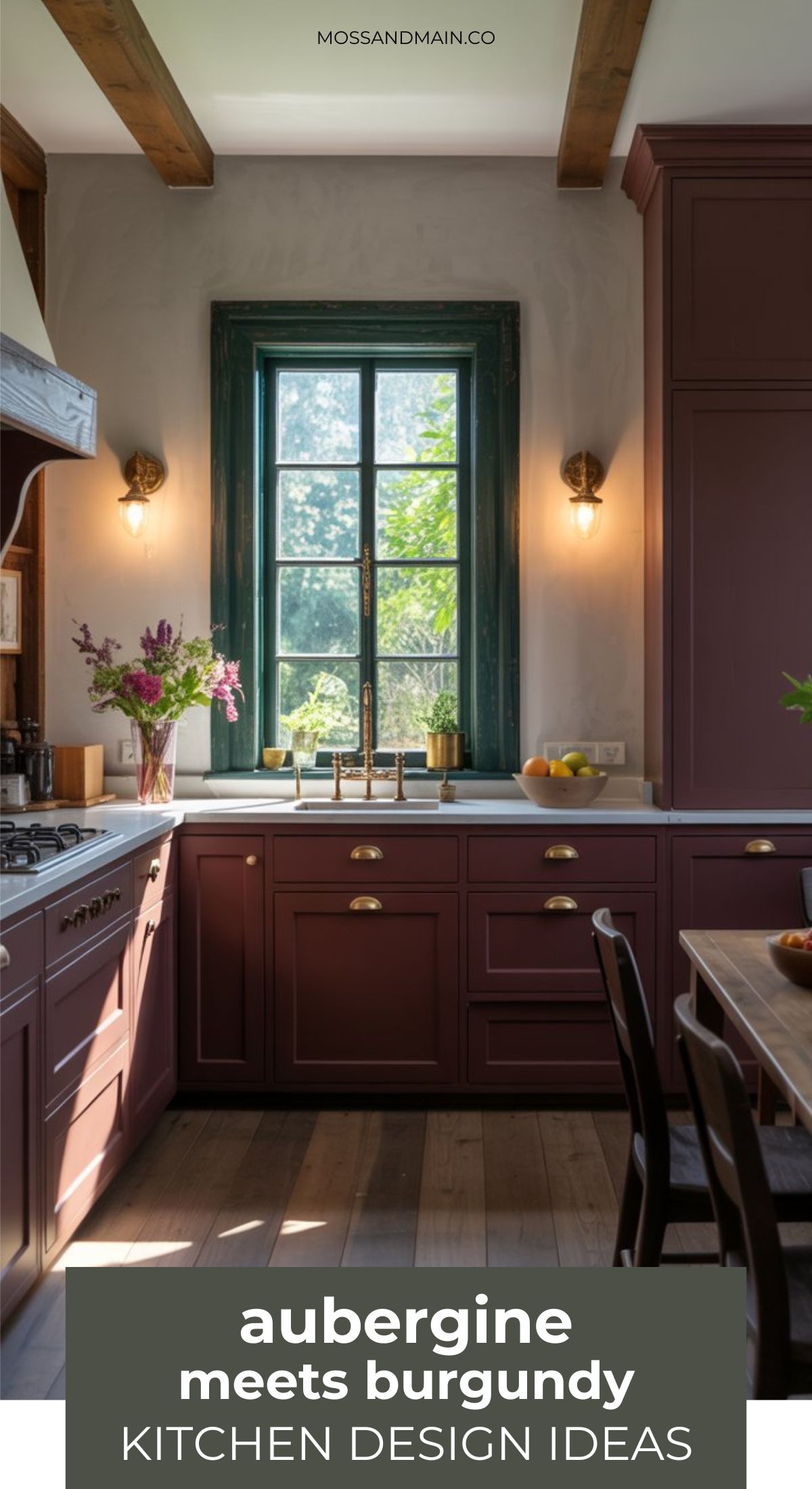 A stylish kitchen features burgundy and aubergine cabinets, a farmhouse sink beneath a window with green trim, golden fixtures, and a vase of flowers. Text reads “aubergine meets burgundy KITCHEN DESIGN IDEAS” for unique Aubergine Kitchen Ideas.