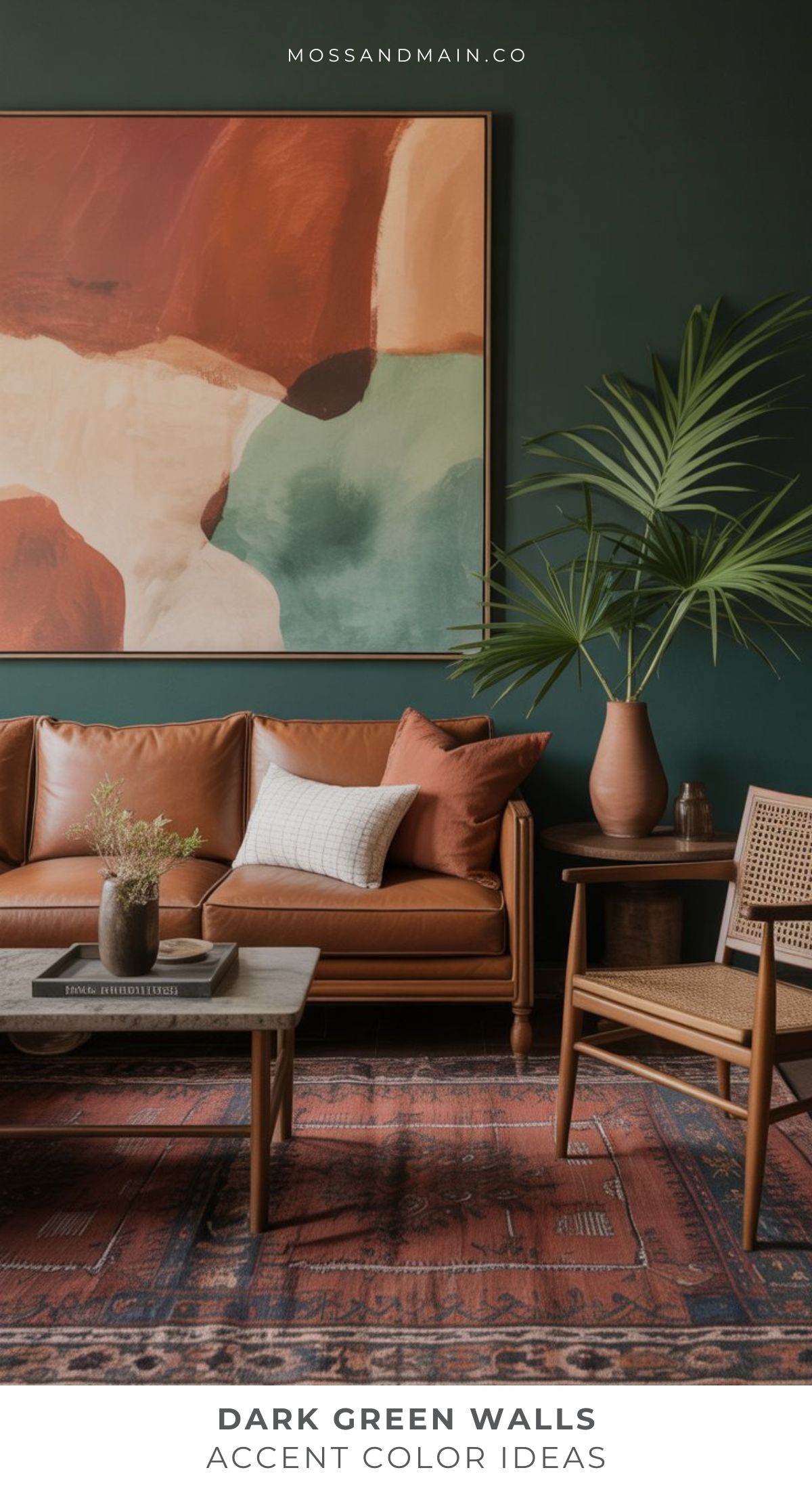 A stylish living room with a dark green color scheme features a large abstract painting, brown leather sofa with cushions, rattan chair, coffee table, potted palm, and patterned red rug. Text reads Colors That Go With Dark Green Walls Accent Color Ideas.