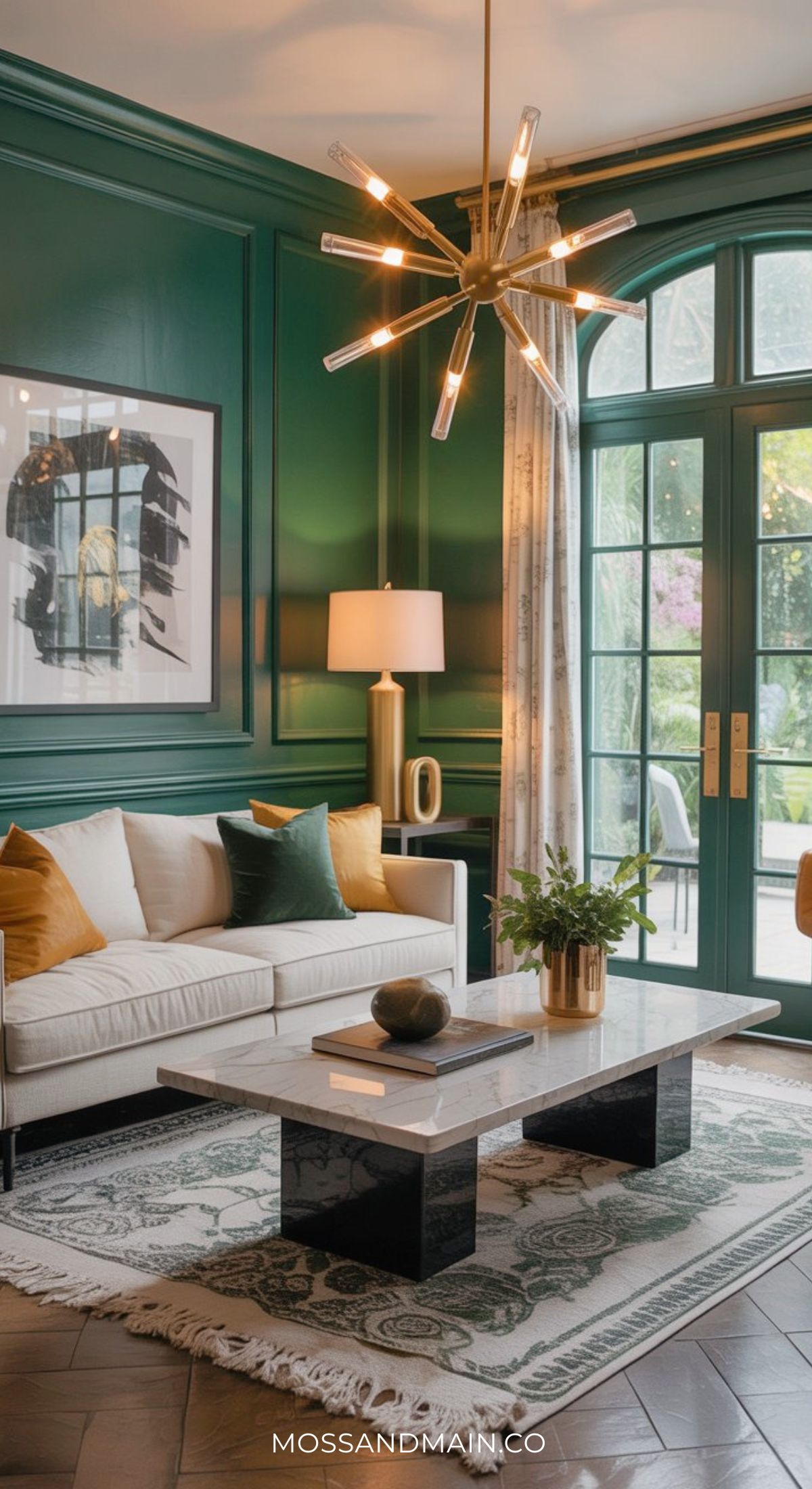 A stylish green and gold living room with paneled walls, a white sofa adorned with colorful pillows, a modern chandelier, a marble coffee table on a patterned rug, and large windows letting in natural light.