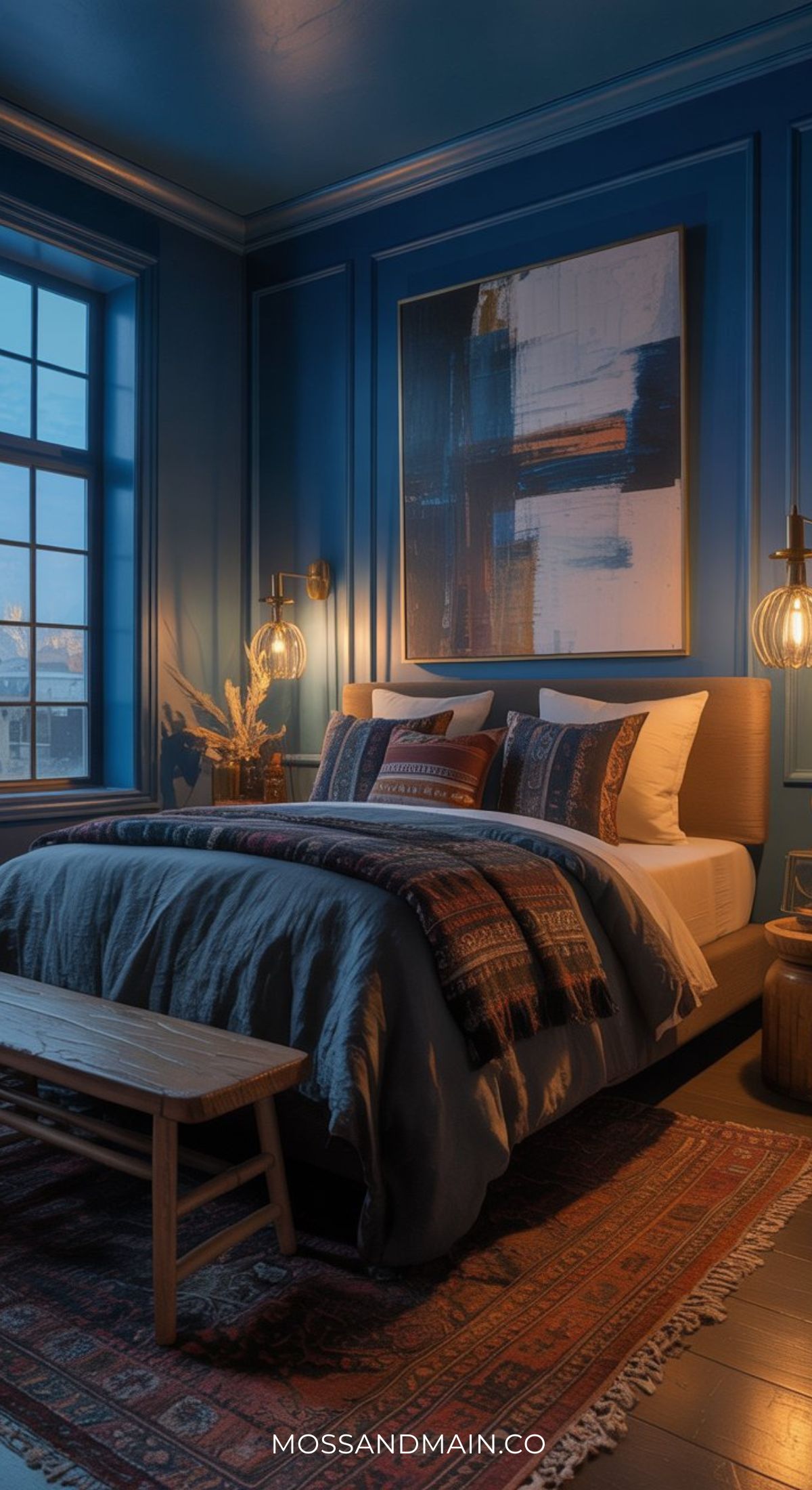 A cozy bedroom with deep blue walls, a large abstract painting above the bed, and patterned bedding creates a warm, inviting Blue Boho Bedroom—perfect inspiration for Pinterest-Worthy Bedrooms.