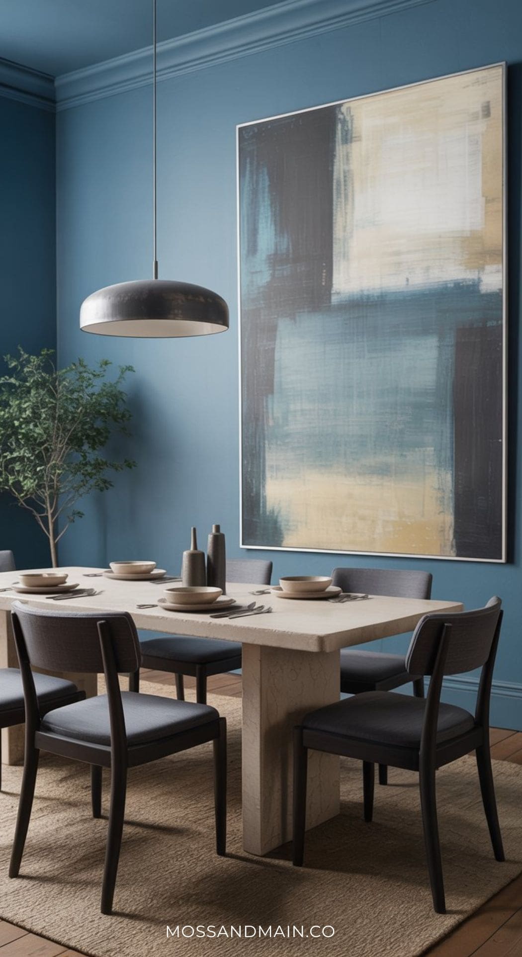 A modern dining room with a stone table, six dark chairs, neutral dishware, a pendant light, a large abstract painting on a blue wall, blue decor accents, a potted plant, and a beige rug—perfect for Blue Dining Room Ideas.